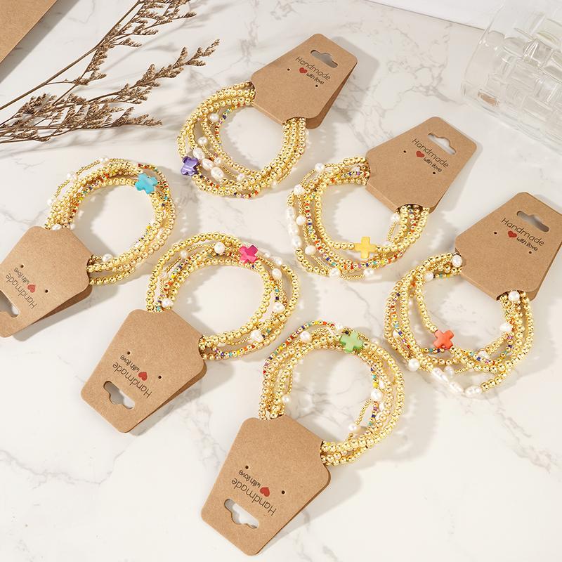 Zestaw 5 kolorowych boho bransoletek z perłami, krzyżykami i koralikami