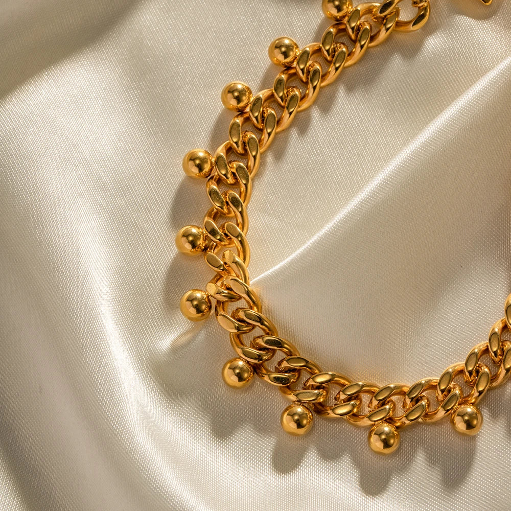 Elegancka bransoletka z ogniwami kubańskimi i koralikami, 18k