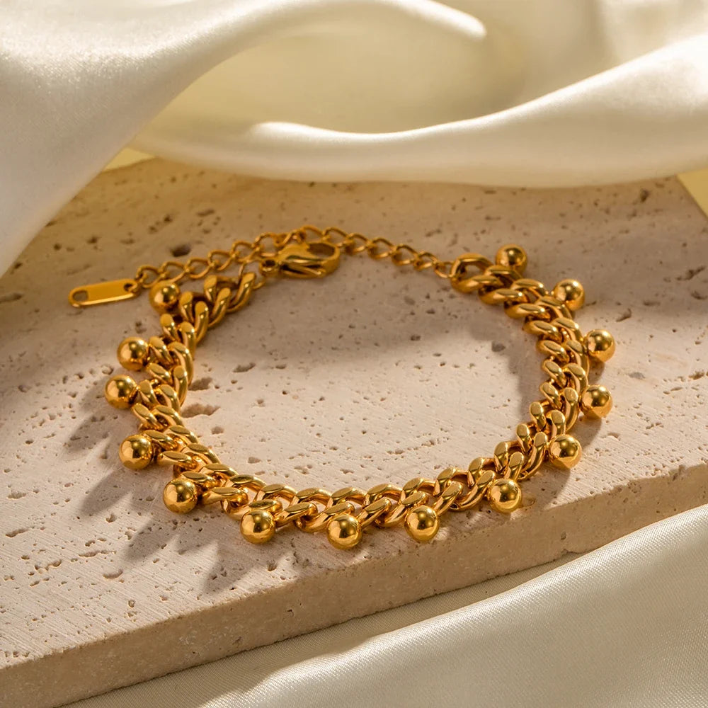 Elegancka bransoletka z ogniwami kubańskimi i koralikami, 18k